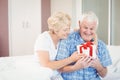 Senior woman giving gift to husband Royalty Free Stock Photo