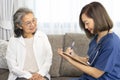 A senior woman giving a health interview to a home visiting nurse Royalty Free Stock Photo