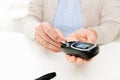 Senior woman with glucometer checking blood sugar Royalty Free Stock Photo