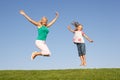 Senior woman with granddaughter jumping in air Royalty Free Stock Photo