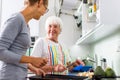 Senior woman/grandmother cooking in a modern kitchen shallow DO