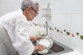 Senior woman or grandmother washing the dishes by hands in the sink,asian elderly clean dirty plates,wash dishes with dishwashing Royalty Free Stock Photo