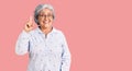 Senior woman with gray hair wearing casual business clothes and glasses pointing finger up with successful idea Royalty Free Stock Photo