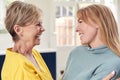 Senior Woman Greeting And Hugging Grown Up Adult Daughter At Home Royalty Free Stock Photo