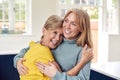 Senior Woman Greeting And Hugging Grown Up Adult Daughter At Home Royalty Free Stock Photo