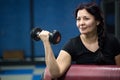 Senior woman in gym working out with dumbbells. close-up. copy space. Royalty Free Stock Photo