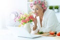 Senior woman in hair rollers at kitchen Royalty Free Stock Photo