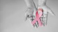 Senior woman hands in black and white support Breast Cancer Day by holding Pink Ribbon Breast Cancer Awareness with copy space. Royalty Free Stock Photo