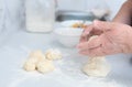 Senior woman hands form blanks for pies on a white kitchen table with blurred grated apple and sugar on background Royalty Free Stock Photo