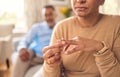 Senior woman, hands and ring in divorce, fight or conflict from disagreement or argument on sofa at home. Elderly couple