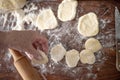 Senior woman hands rolling out dough in flour with rolling pin in her home kitchen Royalty Free Stock Photo