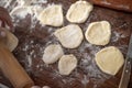 Senior woman hands rolling out dough in flour with rolling pin in her home kitchen Royalty Free Stock Photo