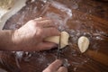 Senior woman hands rolling out dough in flour with rolling pin in her home kitchen Royalty Free Stock Photo