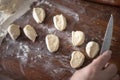 Senior woman hands rolling out dough in flour with rolling pin in her home kitchen Royalty Free Stock Photo