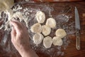 Senior woman hands rolling out dough in flour with rolling pin in her home kitchen Royalty Free Stock Photo