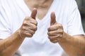 Senior woman hands symbol meaning ` Good ` on white t shirt, Body language concept, Asian Body concept, Close up shot