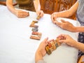 A senior woman is happily playing a domino game with her family in retirement Royalty Free Stock Photo