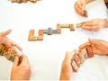 A senior woman is happily playing a domino game with her family in retirement Royalty Free Stock Photo