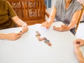 A senior woman is happily playing a domino game with her family in retirement Royalty Free Stock Photo