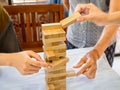 A senior woman is happily playing a wooden block game with her family in retirement, Concept Risk management and strategy plan Royalty Free Stock Photo