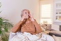 Senior Woman is having allergies and she is using nasal spray to help herself. Elder woman using nasal spray. Nasal spray to help Royalty Free Stock Photo