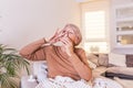 Senior Woman is having allergies and she is using nasal spray to help herself. Elder woman using nasal spray. Nasal spray to help Royalty Free Stock Photo