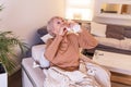 Senior Woman is having allergies and she is using nasal spray to help herself. Elder woman using nasal spray. Nasal spray to help Royalty Free Stock Photo