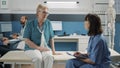 Senior woman having conversation with medical assistant Royalty Free Stock Photo