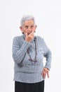 Senior woman having doubts and questions on white background