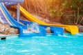 Senior woman having fun on water slide in hotel aquapark Royalty Free Stock Photo