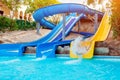 Senior woman having fun on water slide in hotel aquapark Royalty Free Stock Photo