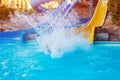 Senior woman having fun on water slide in hotel aquapark Royalty Free Stock Photo