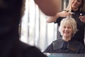 Senior Woman Having Hair Cut By Female Stylist In Hairdressing Salon Royalty Free Stock Photo