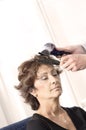 Senior woman having haircut