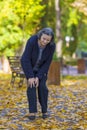 Senior woman having knee pain walking in park Royalty Free Stock Photo