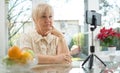 Senior woman having a video call over smart phone at home. Stay at home concept Royalty Free Stock Photo