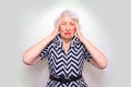 Senior Woman With Head In Hands Looking Weary