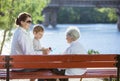 Senior woman, her adult granddaughter and great grandson in park Royalty Free Stock Photo