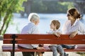 Senior woman, her adult granddaughter and great grandson in park Royalty Free Stock Photo