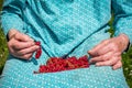 Senior woman in her garden and homegrown redcurrants