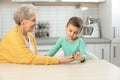 Senior woman with her grandson using digital glucometer. Diabetes control Royalty Free Stock Photo