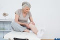 Senior woman with her hands on a painful knee Royalty Free Stock Photo