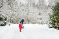 Senior woman and her little grandson shoveling snow off a walkway after massive snowfall. Small child helping outdoors Royalty Free Stock Photo