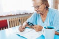 Senior woman enjoys solving a crossword puzzle Royalty Free Stock Photo