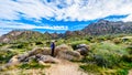 Senior woman hiker enjoying the view of the Valley of the Sun and the McDowell Mountain Range viewed from the Tom`s Thumb Trail Royalty Free Stock Photo
