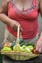 Senior woman holding a basket with vegetables