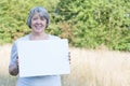 Senior woman holding blank sign Royalty Free Stock Photo