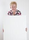 Senior woman holding a blank white sign Royalty Free Stock Photo