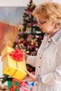 Senior woman holding Christmas gift Royalty Free Stock Photo