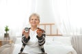 Senior woman holding digital glucometer and pastry. Diabetes diet